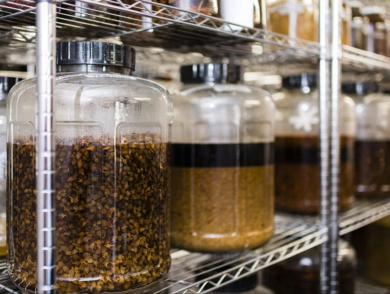 Picture depicting containers holding various herbs suspended in liquid